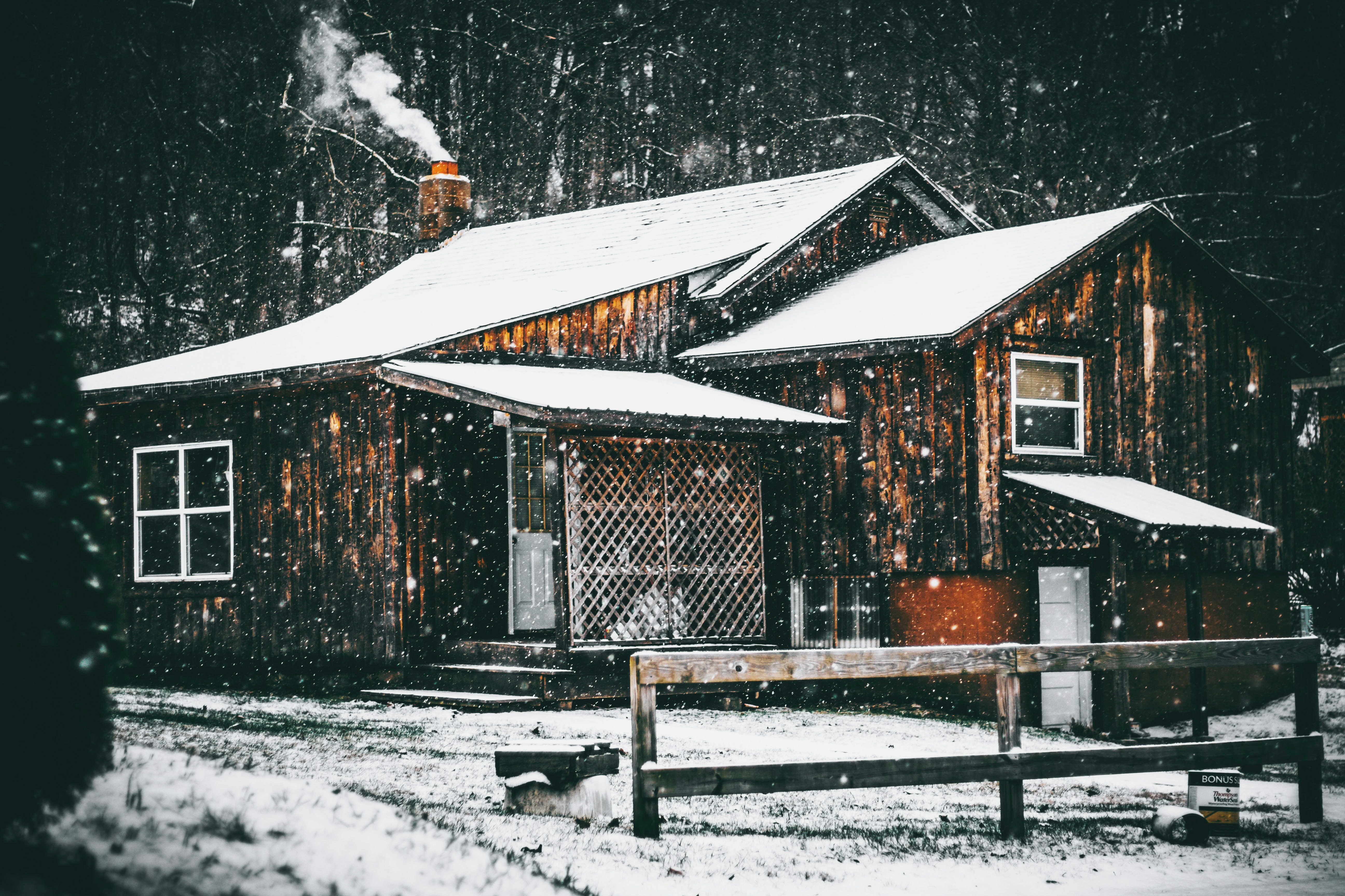 brown wooden house covered by snow